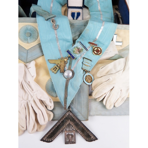 1351 - Two Masonic aprons, sash and assorted jewels contained in a leather case.