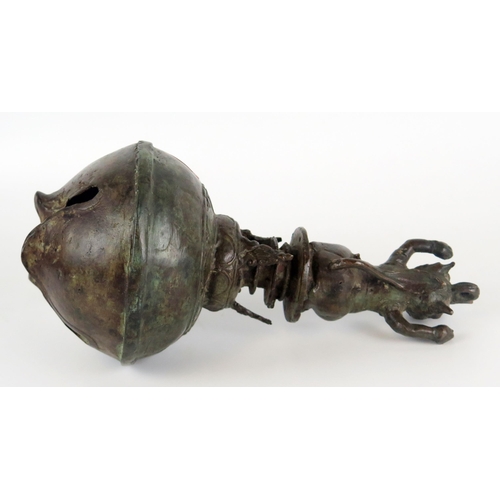 1352 - An Indonesian bronze temple bell, of globular outline, the handle in the form of a Makara, 25cm high... 