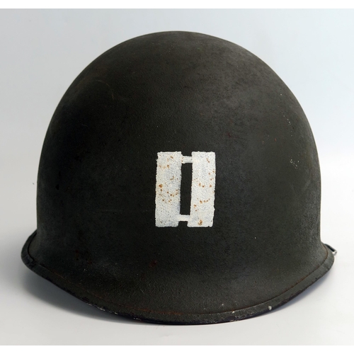 1383 - An American World War II period M1 pattern steel helmet and liner, lacks chin straps.