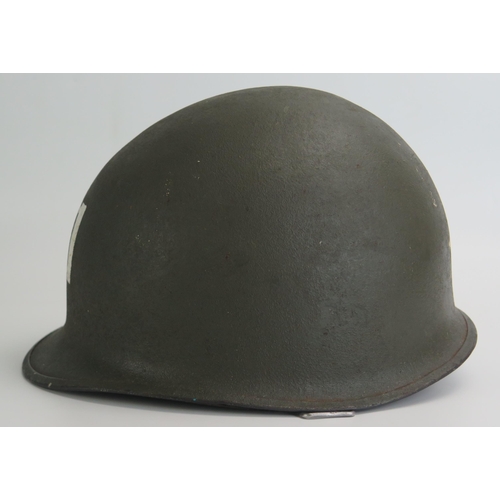 1383 - An American World War II period M1 pattern steel helmet and liner, lacks chin straps.