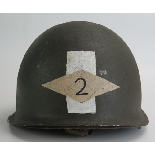 1383 - An American World War II period M1 pattern steel helmet and liner, lacks chin straps.