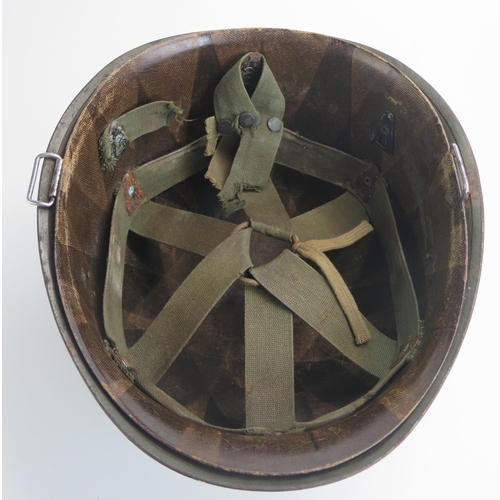 1383 - An American World War II period M1 pattern steel helmet and liner, lacks chin straps.