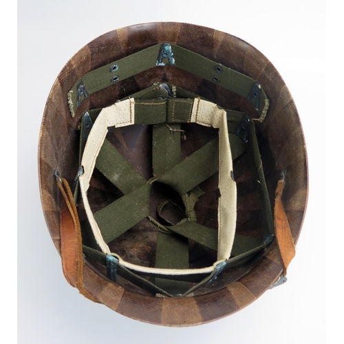 1384 - An American M1 pattern helmet liner with leather chin strap, bears paper label 'NATO' to the front.