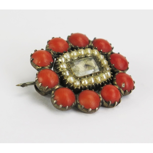 139 - A Georgian Coral and untested Pearl Memorial Brooch with a central glazed panel containing a woven l... 