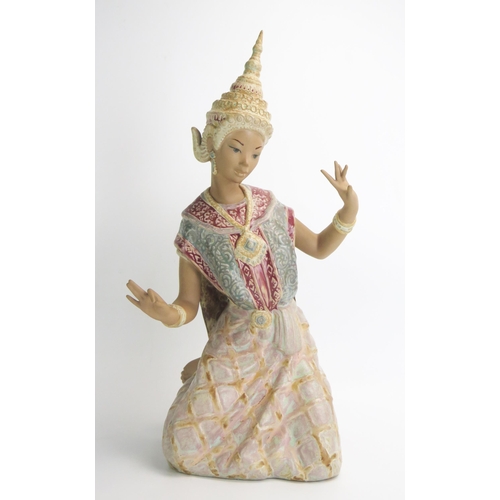 1494 - A Lladro figure of a kneeling Siamese dancer, in traditional headdress, 46cm high