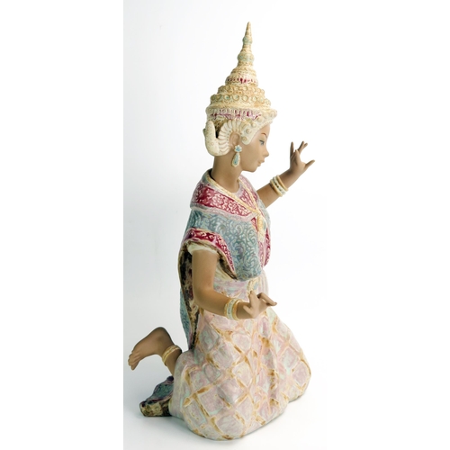 1494 - A Lladro figure of a kneeling Siamese dancer, in traditional headdress, 46cm high