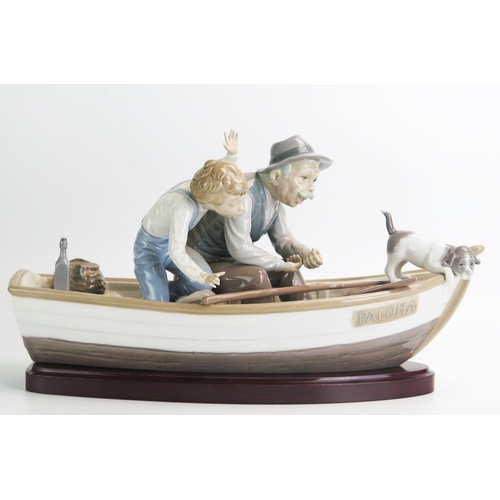 1497 - A Lladro figure group No 5152 'Fishing with Gramps/Paloma', 38cm long. Boy missing fingers and fishi... 