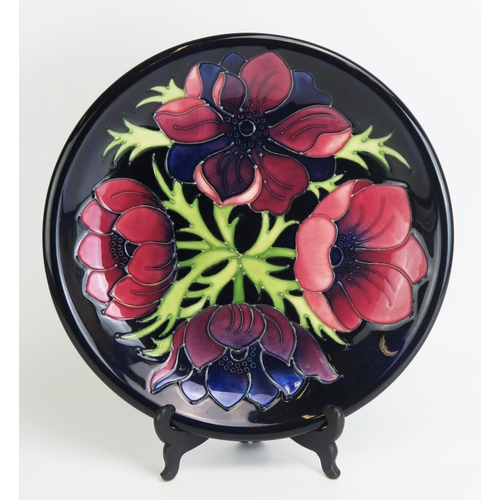 1506 - A Moorcroft pottery plate  'Anemone' pattern decoration, designed by W. Moorcroft, Circa 1988, 26cm ... 