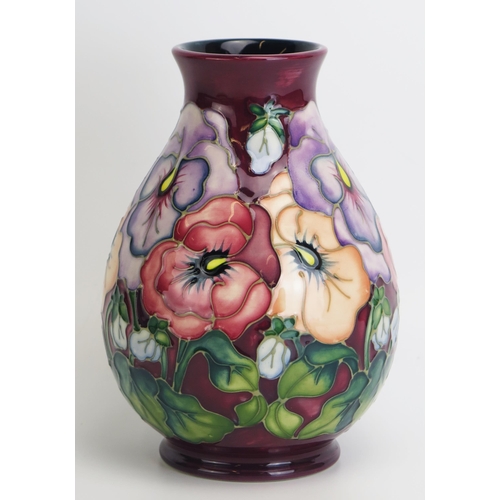 1516 - A Moorcroft pottery vase, with 'Pansy' pattern decoration by Rachel Bishop, released in 1993, 19.5cm... 