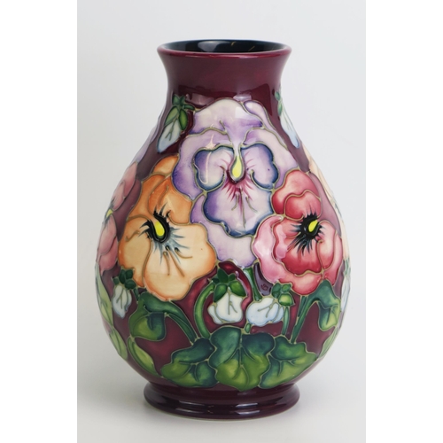 1516 - A Moorcroft pottery vase, with 'Pansy' pattern decoration by Rachel Bishop, released in 1993, 19.5cm... 