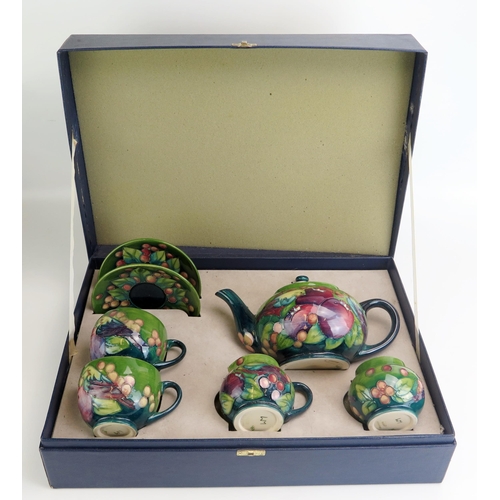 1521 - A Moorcroft pottery tea set for two with 'Finches' pattern decoration by Sally Tuffin, includes teap... 