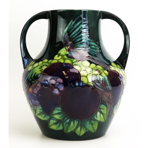 1530 - A Moorcroft pottery twin handled vase, with 'Teal Finches' designed by Sally Tuffin, released in 199... 