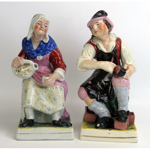 1537 - A pair of Staffordshire pottery figures 'The Cobbler and His Wife', 31cm high