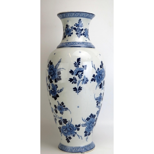 1539 - A large 20th century delft vase, with central cartouche decorated with a castle by a riverside, encl... 