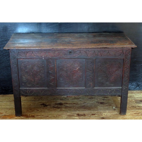 1610 - A late 18th century carved oak coffer, the rectangular hinged top with triple carved panelled front,... 