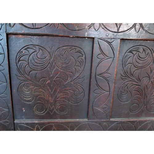 1610 - A late 18th century carved oak coffer, the rectangular hinged top with triple carved panelled front,... 