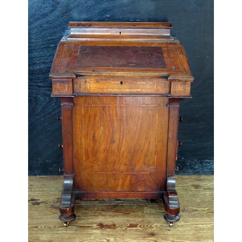 1611 - A Victorian walnut and satinwood strung davenport, with hinged writing surface enclosing a fitted in... 