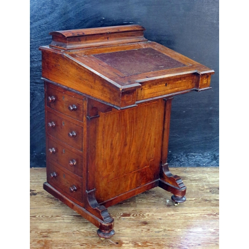 1611 - A Victorian walnut and satinwood strung davenport, with hinged writing surface enclosing a fitted in... 