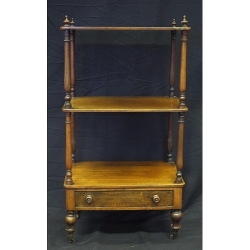 1617 - A Victorian mahogany three tier what not, with turned columns with single drawer to the base, on tur... 