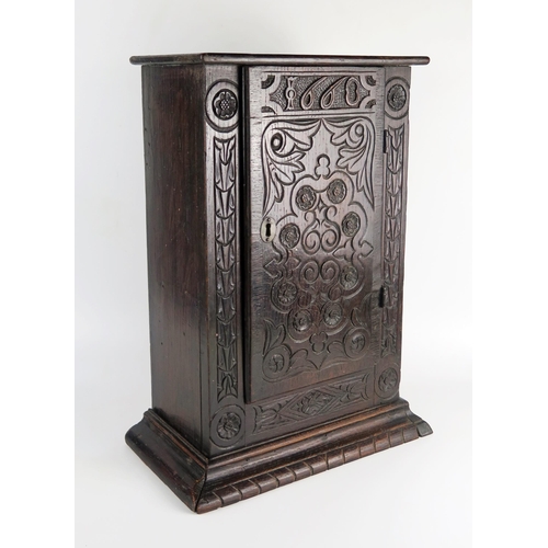 1622 - An antique oak table top cabinet, with plain top and associated carved panel door dated 1668, enclos... 