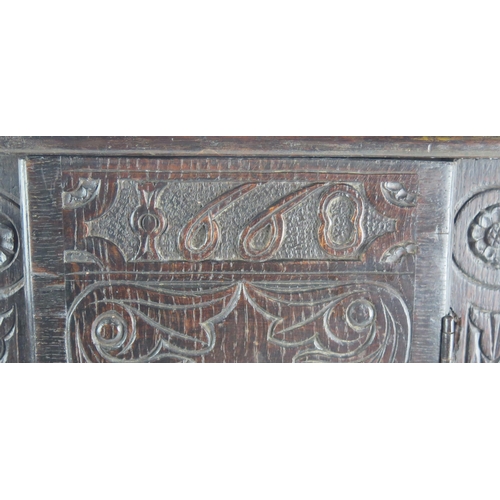 1622 - An antique oak table top cabinet, with plain top and associated carved panel door dated 1668, enclos... 