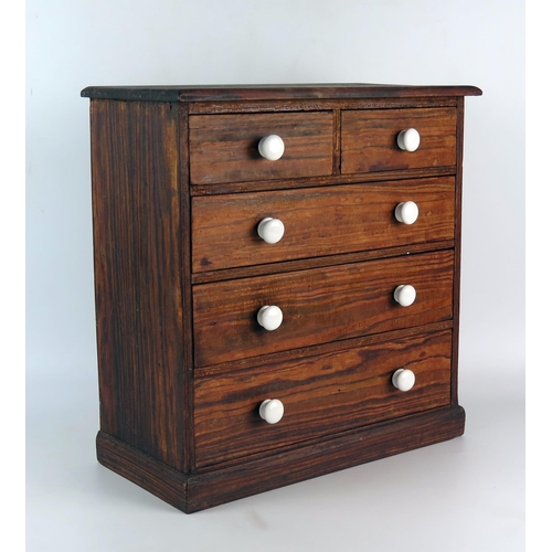 1625 - A miniature pitch pine chest of two short and three long graduated drawers on a plinth base, 33cm wi... 