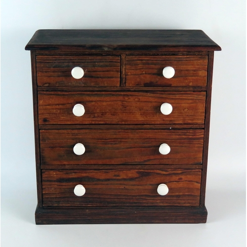 1625 - A miniature pitch pine chest of two short and three long graduated drawers on a plinth base, 33cm wi... 