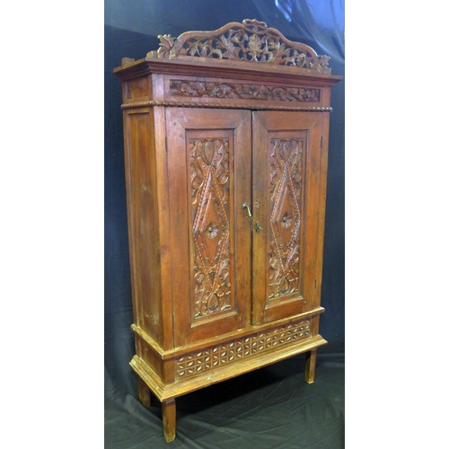 1626 - A continental walnut cabinet, with arched and carved foliate and scroll pediment, floral decorated f... 