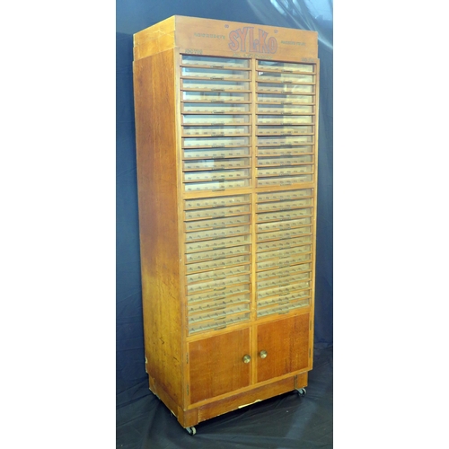 1627 - A Dewhurst's machine twist SYLKO haberdashery cabinet, with glazed front sliding drawers for cotton ... 