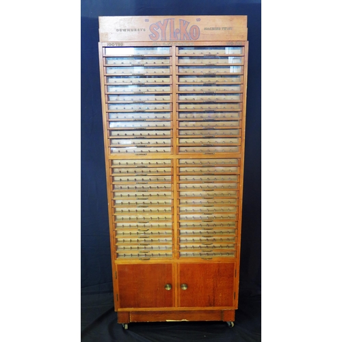 1627 - A Dewhurst's machine twist SYLKO haberdashery cabinet, with glazed front sliding drawers for cotton ... 