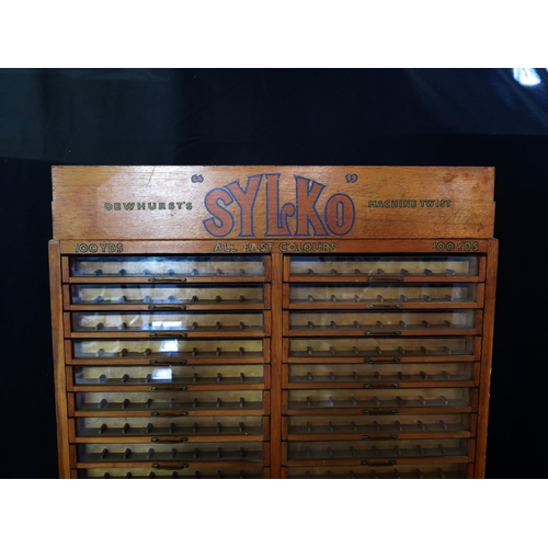 1627 - A Dewhurst's machine twist SYLKO haberdashery cabinet, with glazed front sliding drawers for cotton ... 