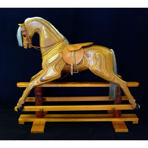 1632 - Relko, Devon, a late 20th century polished wood rocking horse, with open mouth, flared nostrils, ins... 