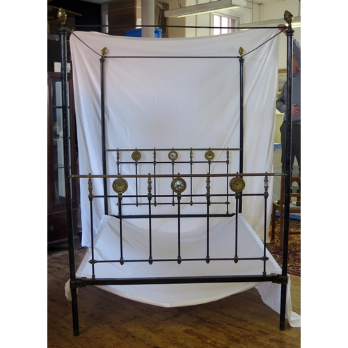 1636 - A Late Victorian tubular metal four-poster double bed, with bed ends, side rails and drapery runners... 