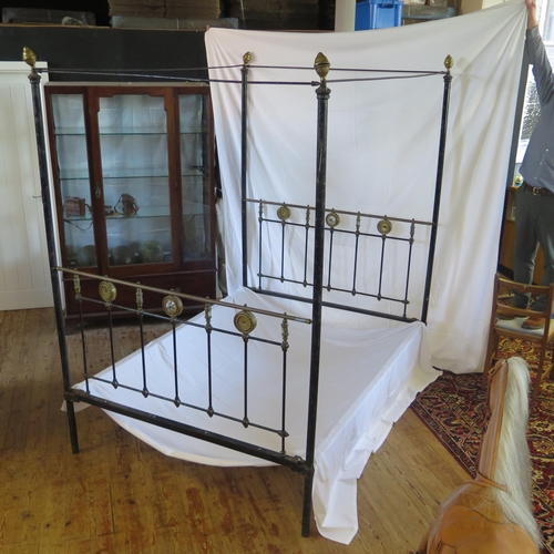 1636 - A Late Victorian tubular metal four-poster double bed, with bed ends, side rails and drapery runners... 