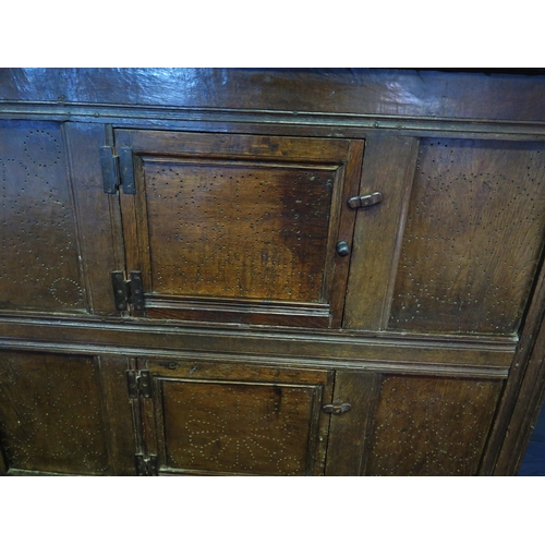 1638 - An 18th century oak dresser, with ledged top, with panelled cupboard door having pierced floral deco... 