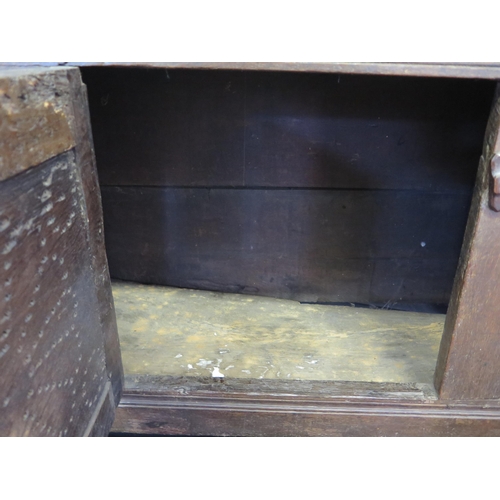 1638 - An 18th century oak dresser, with ledged top, with panelled cupboard door having pierced floral deco... 