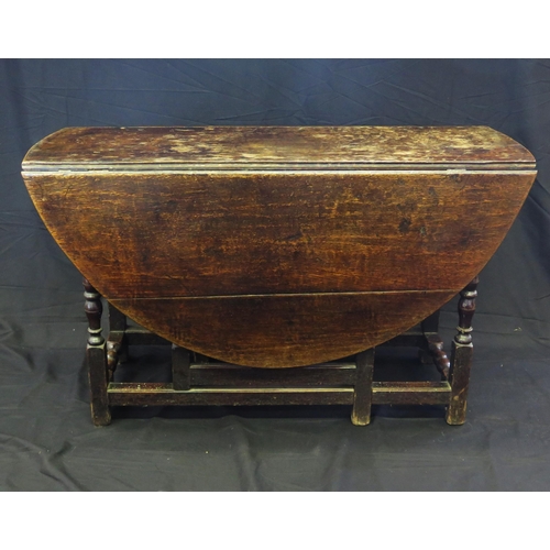 1643 - A late 18th century oak drop flap table, with hinged D-shaped flaps on a gate leg action, with turne... 