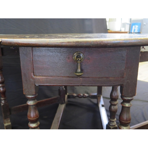 1643 - A late 18th century oak drop flap table, with hinged D-shaped flaps on a gate leg action, with turne... 