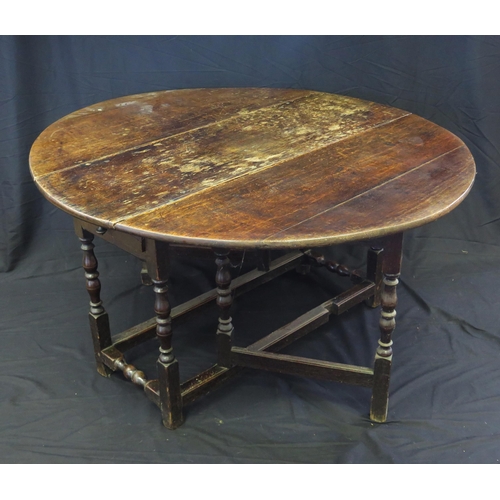 1643 - A late 18th century oak drop flap table, with hinged D-shaped flaps on a gate leg action, with turne... 