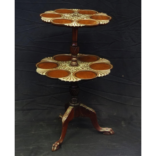 1645 - A Mahogany two tier dumb waiter in the Georgian style, the circular top with carved flowerhead and s... 