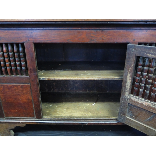 1646 - A late 18th century oak food hutch, with rectangular top with panelled and spindle decorated door en... 