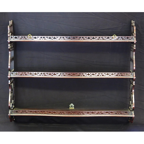 1647 - A set of three 19th century mahogany wall shelves of serpentine outline, with fret carved sides, 88c... 