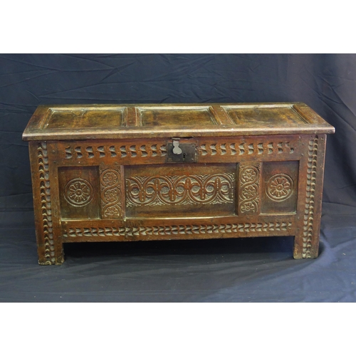 1648 - An 18th century and later three panelled coffer, with rectangular hinged lid, with triple carved pan... 