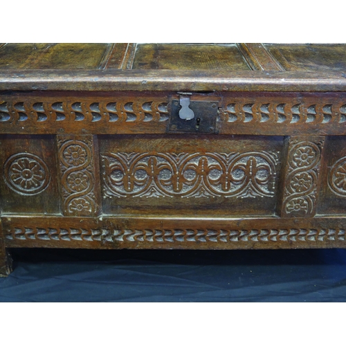 1648 - An 18th century and later three panelled coffer, with rectangular hinged lid, with triple carved pan... 