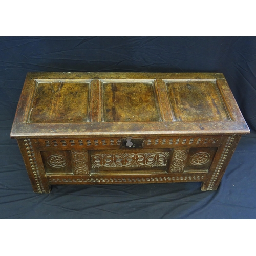 1648 - An 18th century and later three panelled coffer, with rectangular hinged lid, with triple carved pan... 