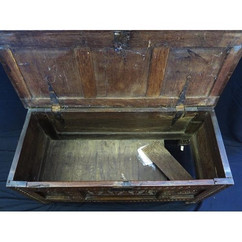 1648 - An 18th century and later three panelled coffer, with rectangular hinged lid, with triple carved pan... 