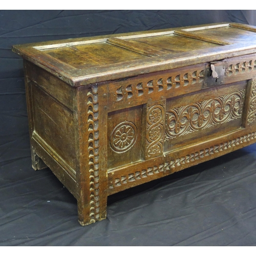 1648 - An 18th century and later three panelled coffer, with rectangular hinged lid, with triple carved pan... 