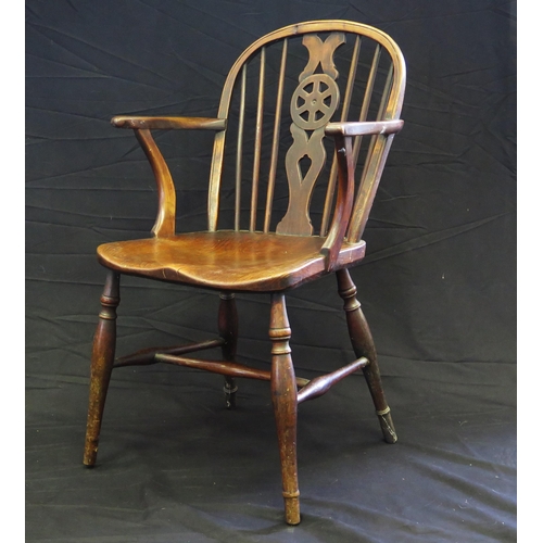 1652 - An elm wheel-back elbow chair with solid seat on turned under-framing, A Regency giltwood circular c... 