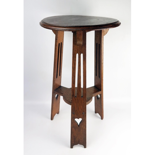 1653 - An Edwardian oak jardinière stand, the circular top with a moulded edge, raised on three pierced sup... 