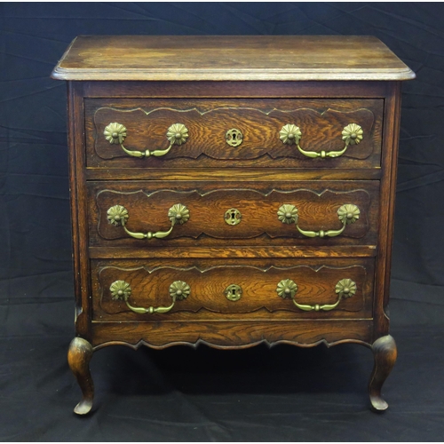 1655 - A continental oak chest of rectangular outline, the top with a moulded edge, containing three drawer... 